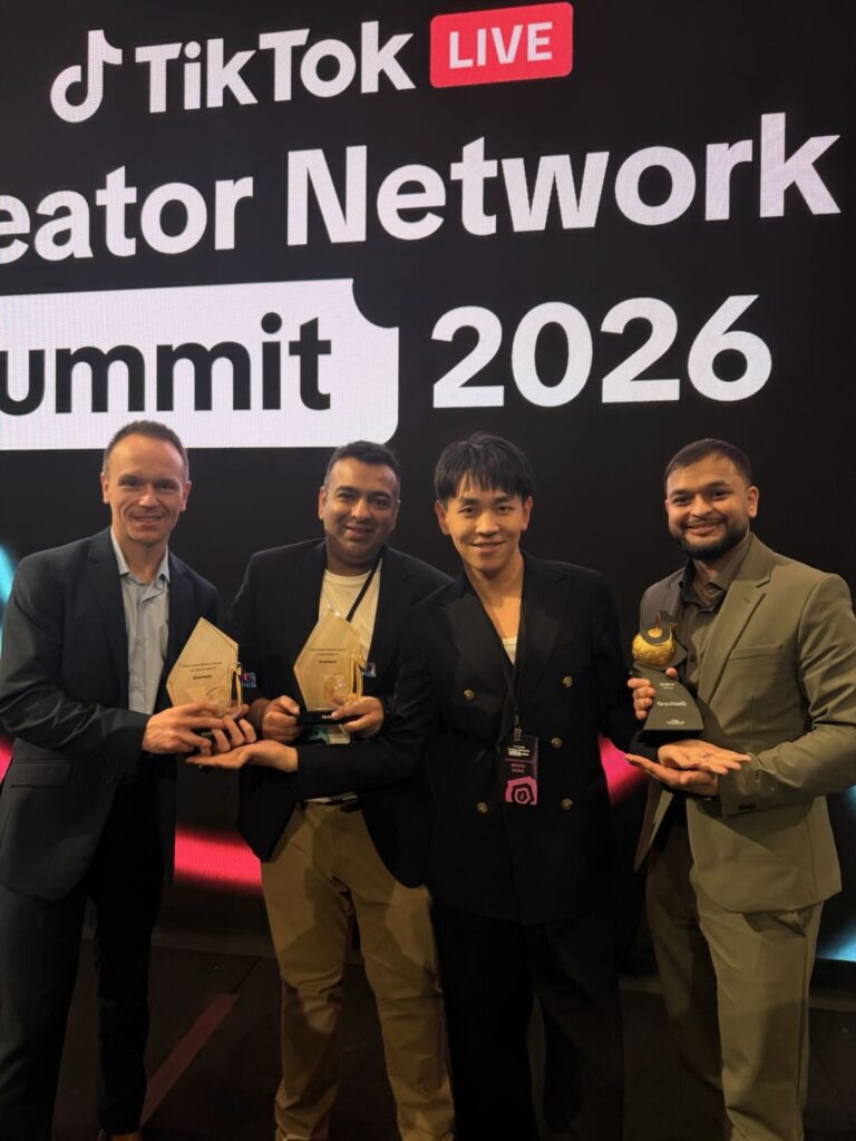 GravitsQ team holding awards